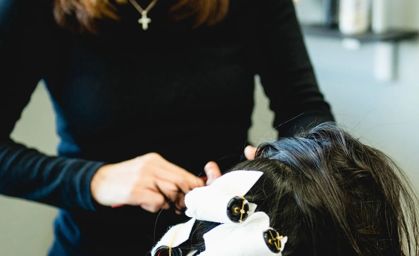 Korean digital perm rods being wound into a client’s hair